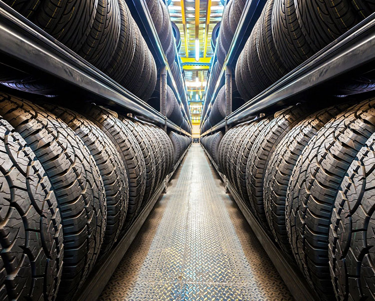 A row of tires in a warehouse.